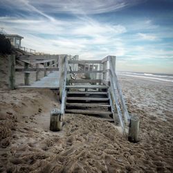 Lifeguard hut on beach against sky