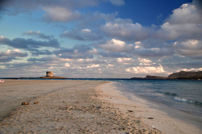 Scenic view of beach against sky during sunset