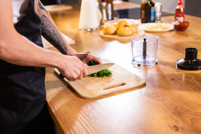 Midsection of man preparing food on table