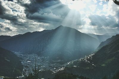 Scenic view of mountains against cloudy sky