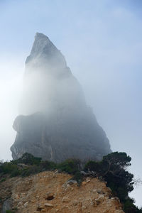 Low angle view of rock formation against sky