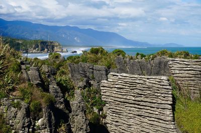 The pancakes in new zealand, geological formations and view of a bay and mountains 