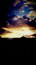 Silhouette of landscape against cloudy sky