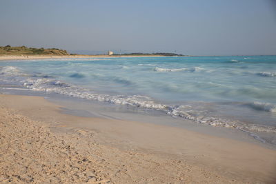 Scenic view of beach against clear sky