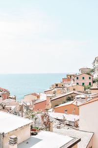High angle view of townscape by sea against sky