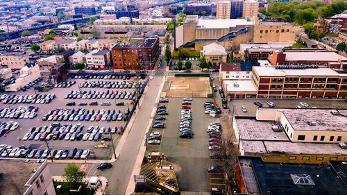 High angle view of vehicles parked at parking lot in city