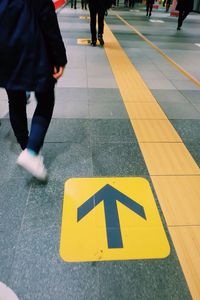 Low section of people walking on street