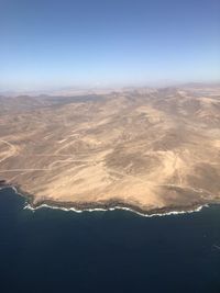 Aerial view of landscape against clear blue sky