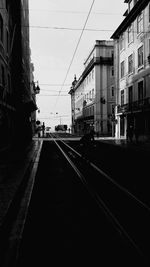 Street amidst buildings against sky in city