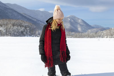 Woman is having winter fun on a snowy, sunny day in lika, croatia
