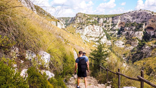 Rear view of man standing on mountain