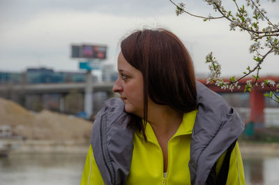 Portrait of young woman looking away outdoors