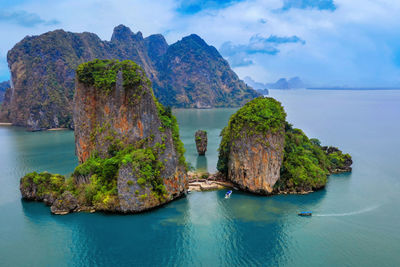 Scenic view of rock formation in sea against sky