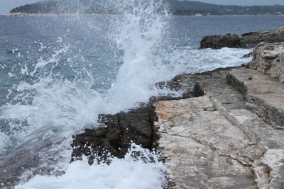 View of waves splashing on rocky coast