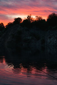 Scenic view of lake against orange sky