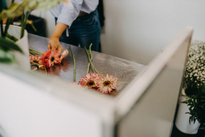 Midsection of woman holding flower