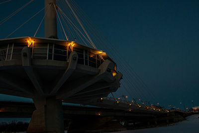 Low angle view of illuminated bridge against sky at night