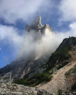 Scenic view of mountains against cloudy sky during foggy weather