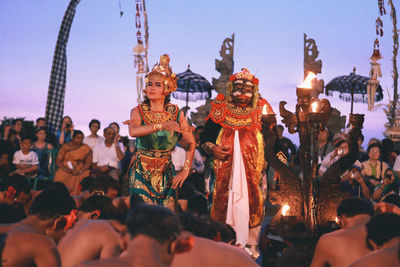 Group of people in temple against sky