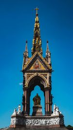 Low angle view of statue against blue sky