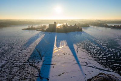 Aerial winter sunny day view of frozen galve lake in trakai, lithuania