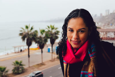 Close-up of woman before city beach 