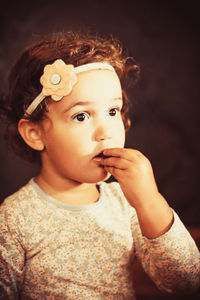 Portrait of little girl eating chocolate.