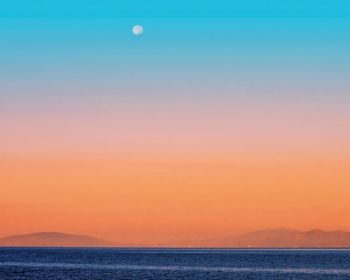 Scenic view of sea against sky at sunset