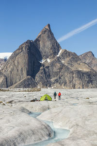 Climbers at basecamp on glacier below mt. loki, baffin island.