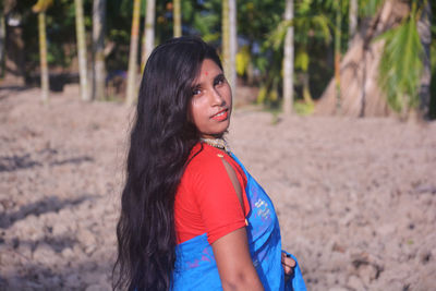 Portrait of a beautiful young woman in forest