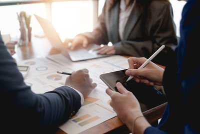Midsection of business colleagues working at office