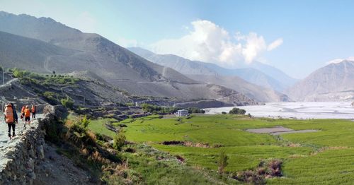 Panoramic view of field and mountains against sky