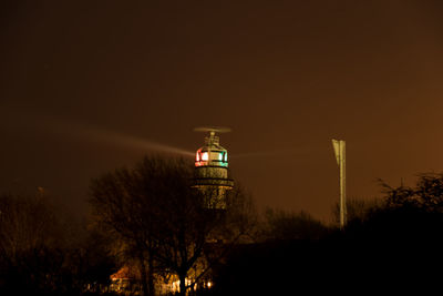 Low angle view of illuminated building against sky at night