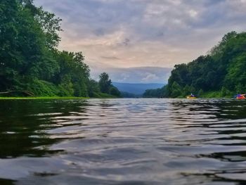 Scenic view of lake against sky at sunset