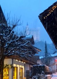 Low angle view of houses against sky during winter