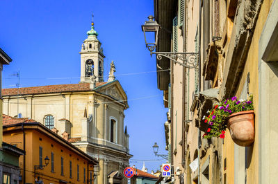 Low angle view of bell tower against clear blue sky