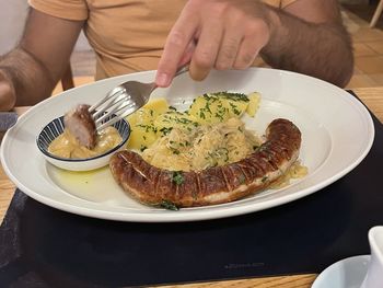 Close-up of person preparing food in plate