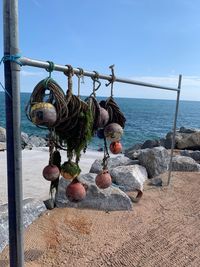 Clothes hanging on rock at beach against clear sky