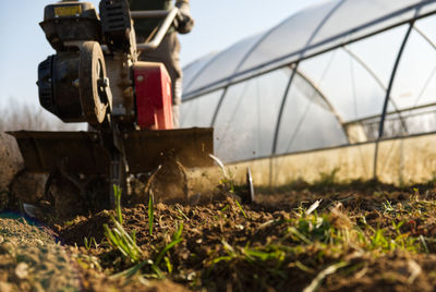 Narrow perspective from the ground of a cutter ploughing the ground