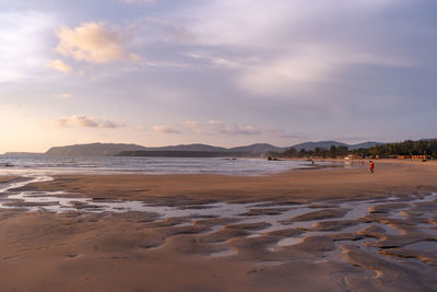 Scenic view of beach against sky during sunset