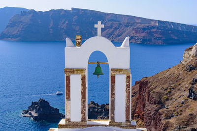 Scenic view of sea by buildings against sky