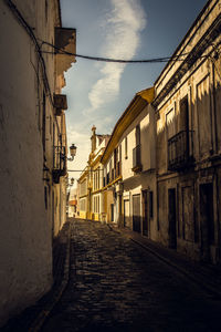 Empty alley amidst buildings in city