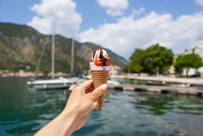 Very beautiful embankment of the bay of kotor, montenegro. the girl is holding an ice cream.