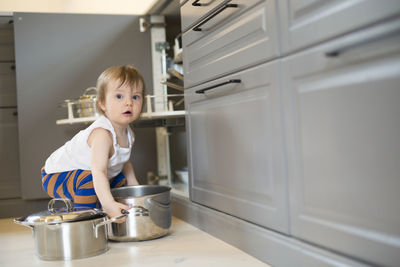 Girl playing with saucepans
