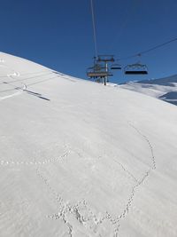 Ski lift against clear sky