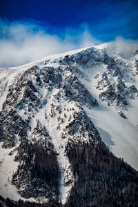 Scenic view of snow covered mountains against sky