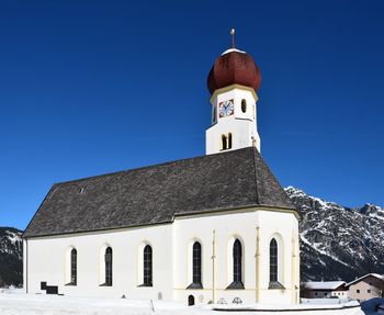 Low angle view of building against clear blue sky