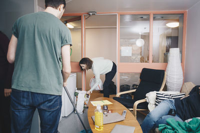 Rear view of friends standing in corridor