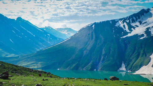 Scenic view of lake and mountains against sky