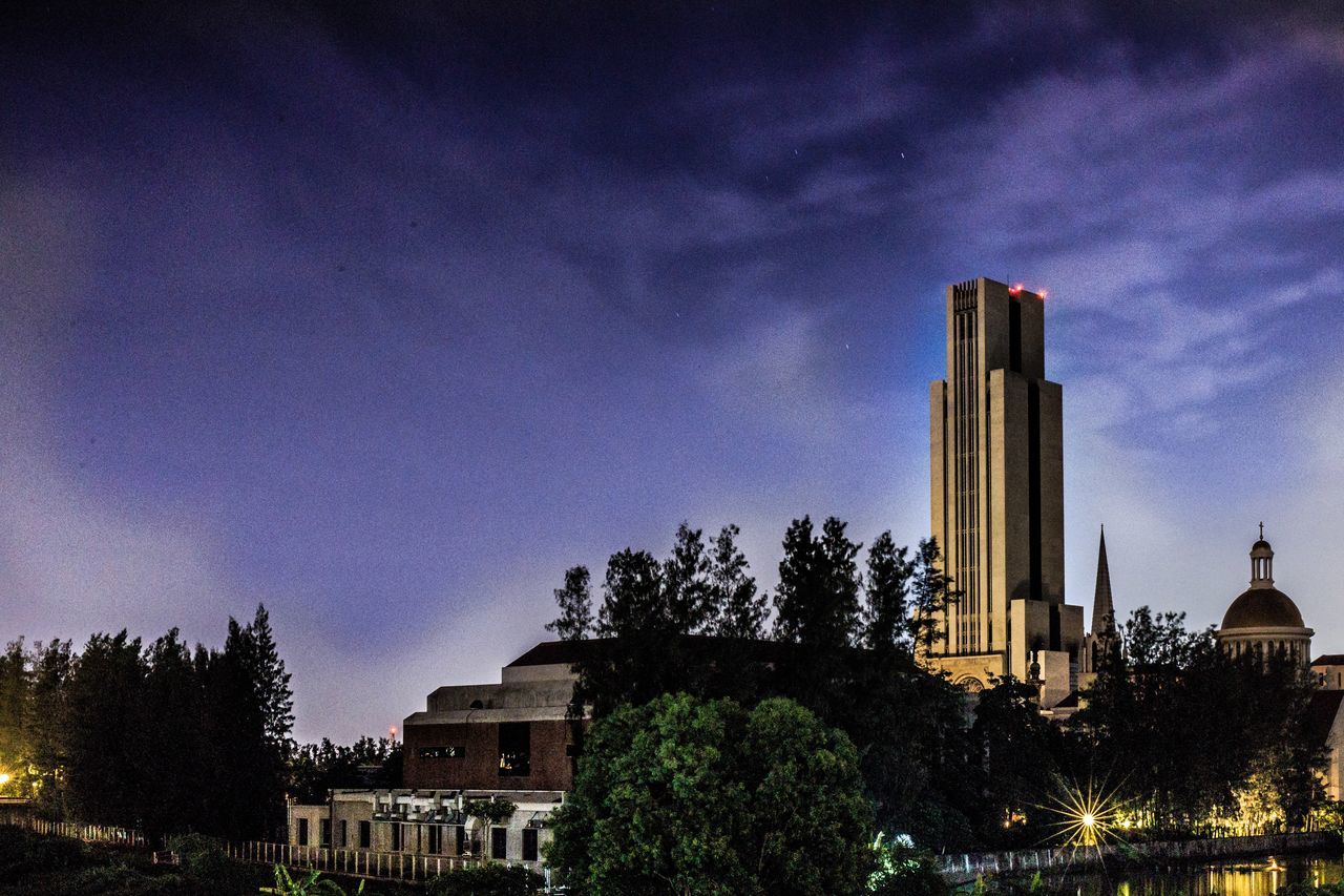 LOW ANGLE VIEW OF BUILDINGS AT DUSK